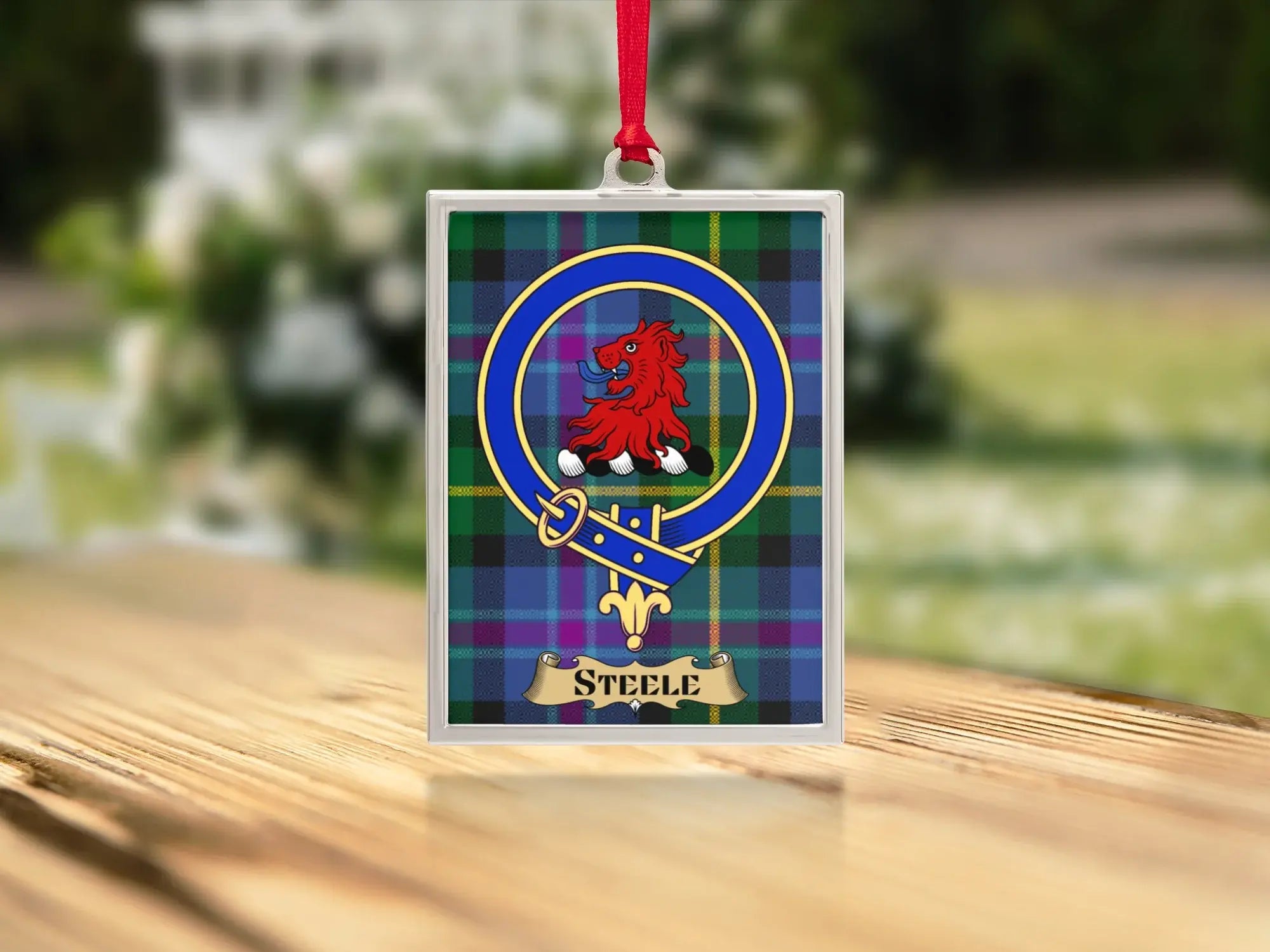 Close-up of the Steele family crest on a polished silver-frame metal ornament