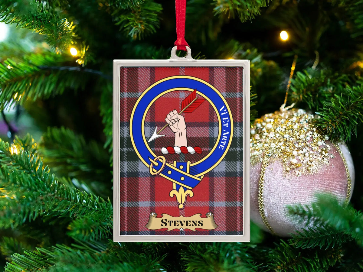 Stevens clan crest Christmas ornament in a silver frame on a tartan background