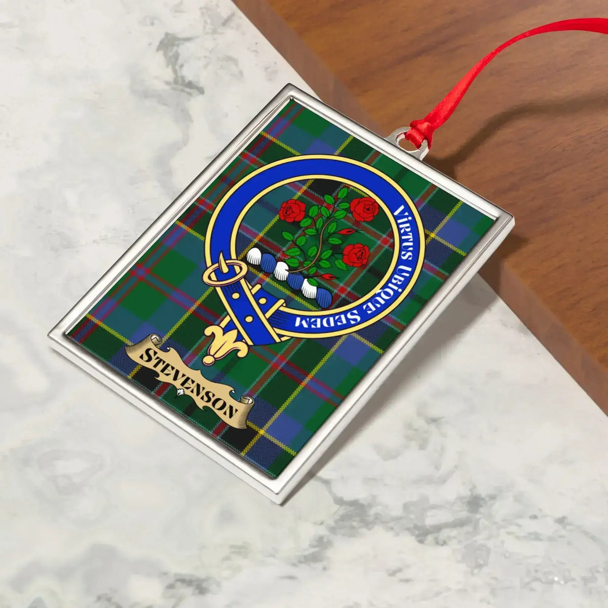 Stevenson ornament hanging from a Christmas tree branch by its satin ribbon