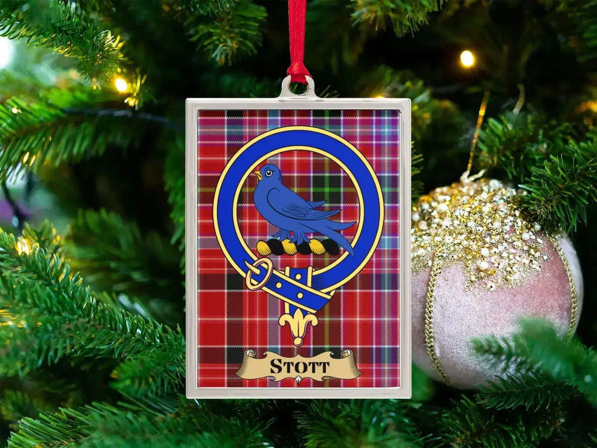 Stott clan crest Christmas ornament in a silver frame on a tartan background