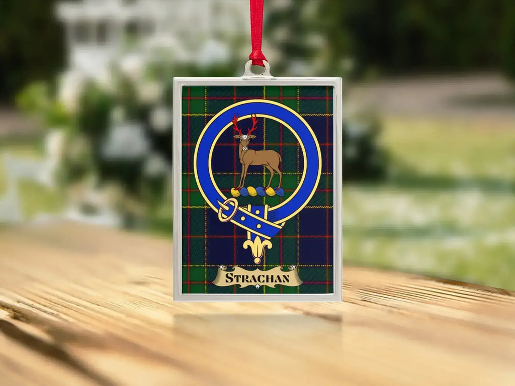 Close-up of the Strachan family crest on a polished silver-frame metal ornament