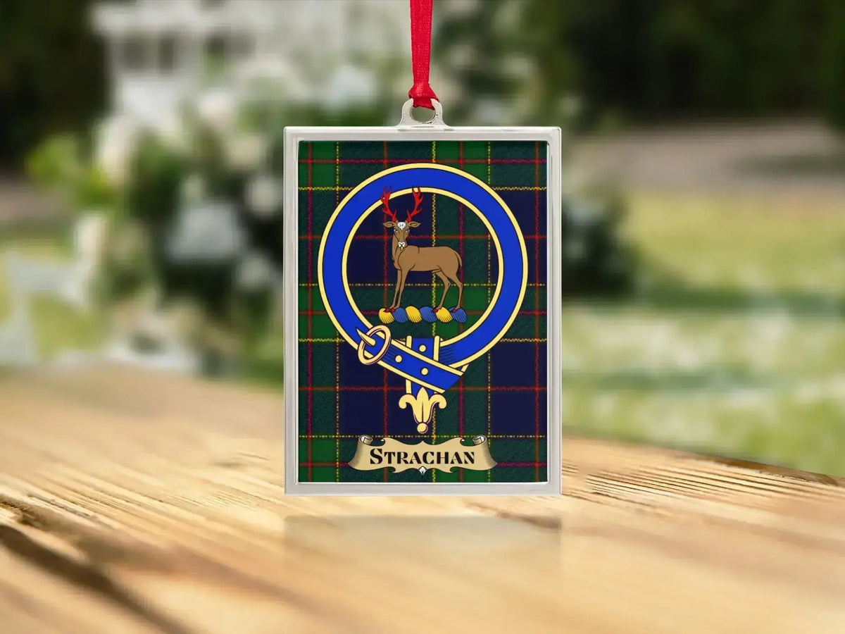 Close-up of the Strachan family crest on a polished silver-frame metal ornament