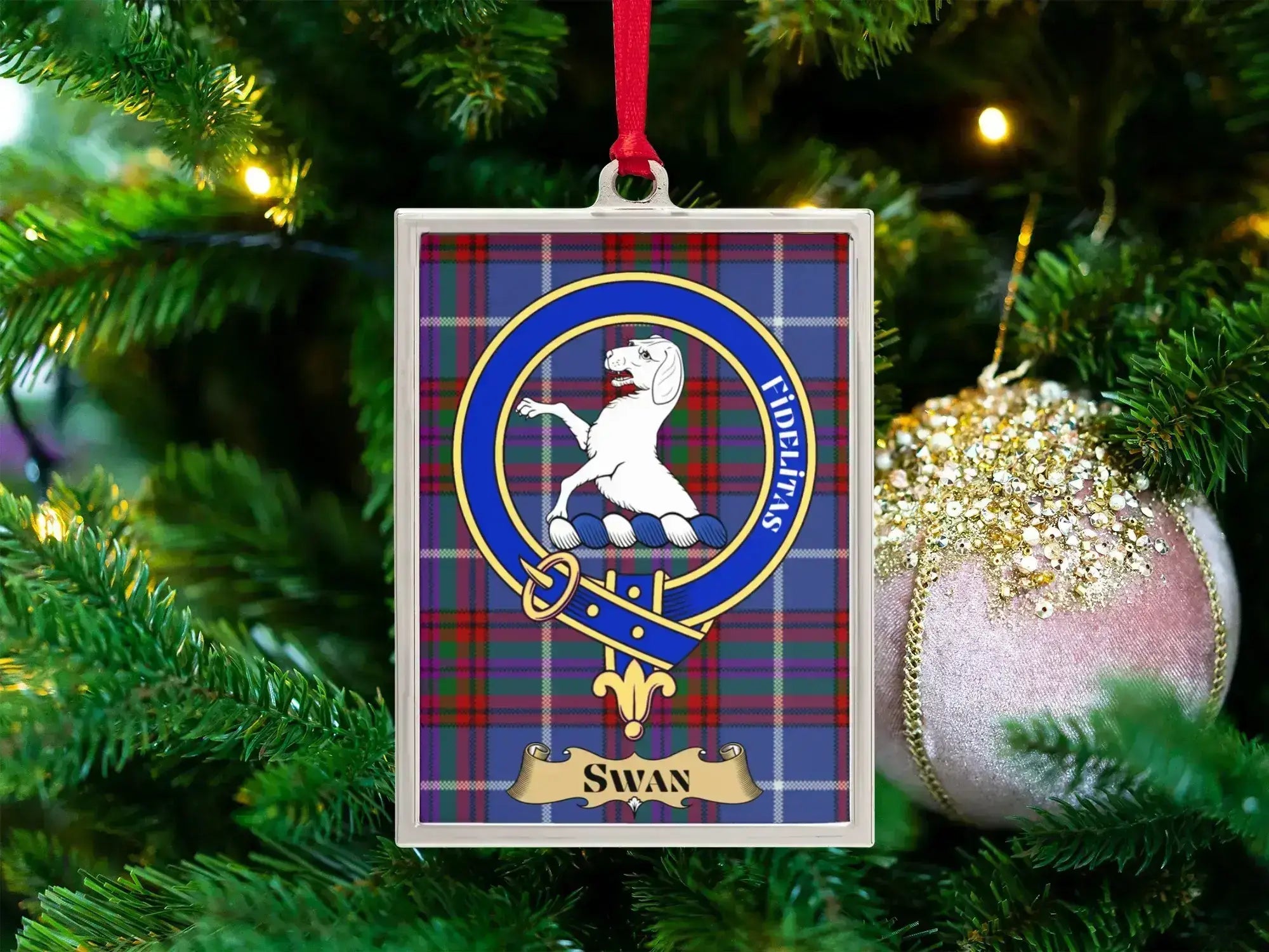Swan clan crest Christmas ornament in a silver frame on a tartan background