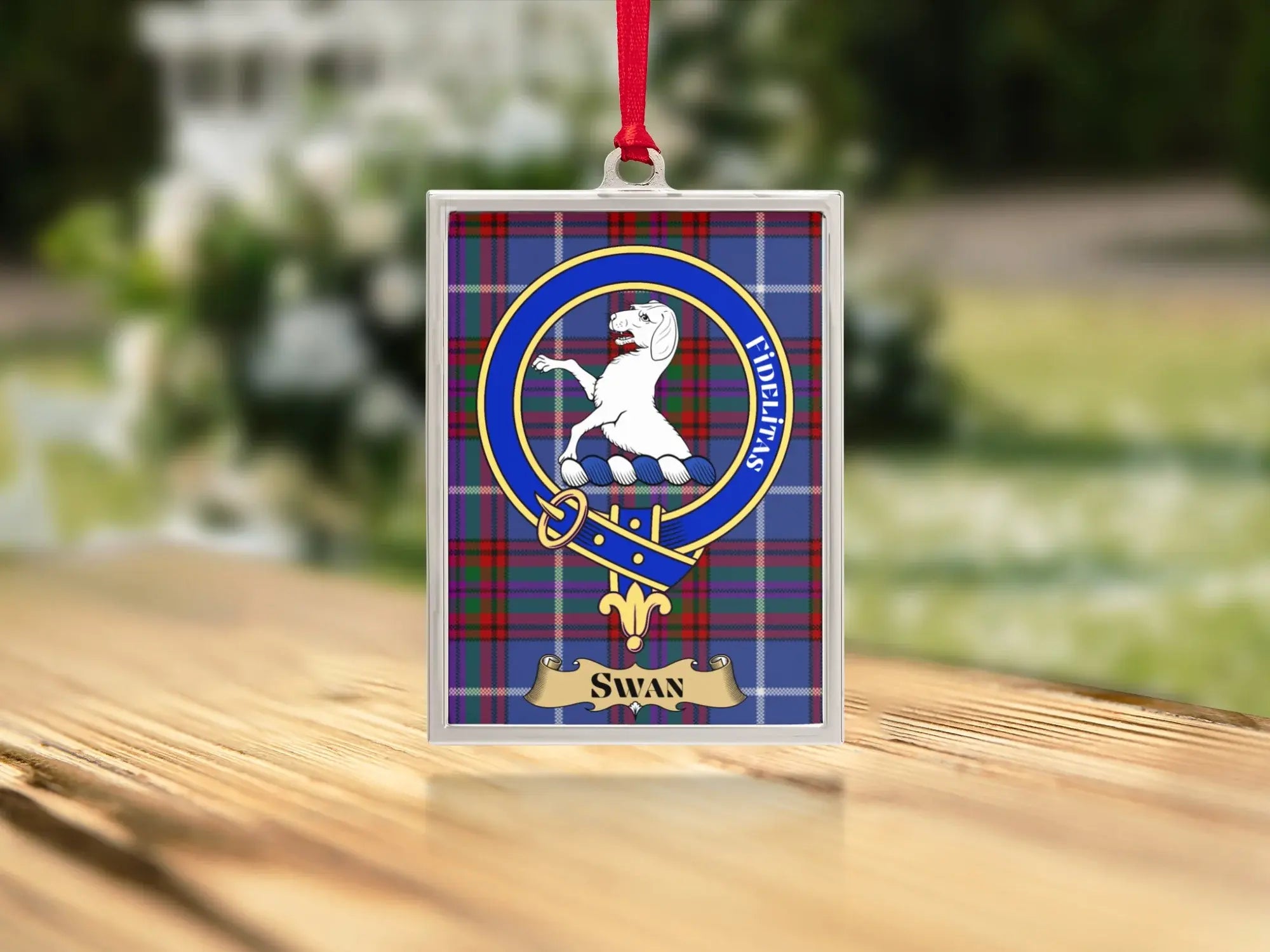 Close-up of the Swan family crest on a polished silver-frame metal ornament
