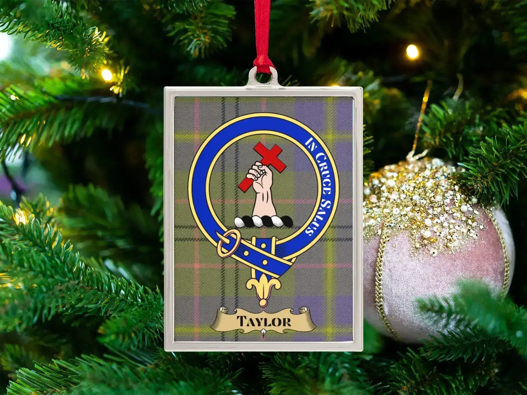 Taylor clan crest Christmas ornament in a silver frame on a tartan background