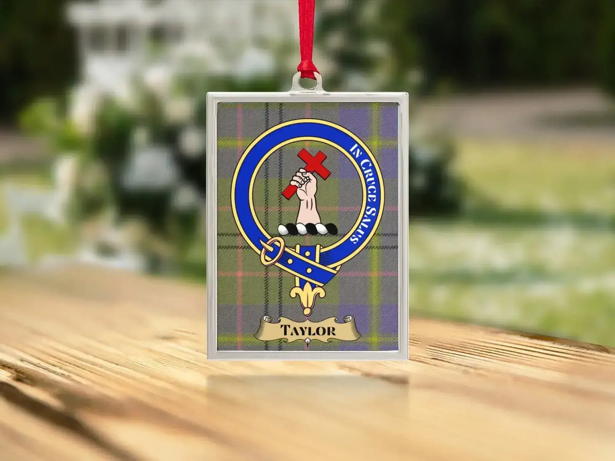 Close-up of the Taylor family crest on a polished silver-frame metal ornament
