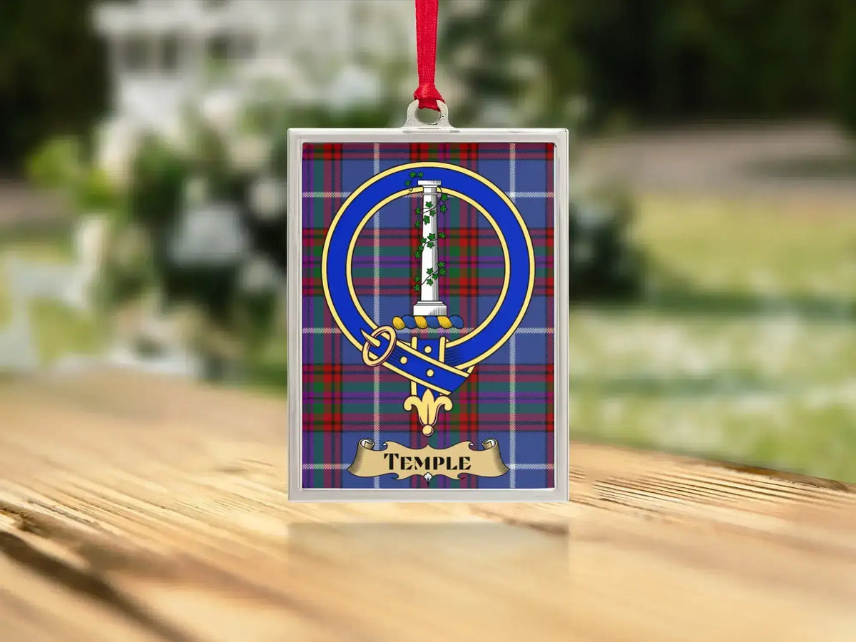 Close-up of the Temple family crest on a polished silver-frame metal ornament
