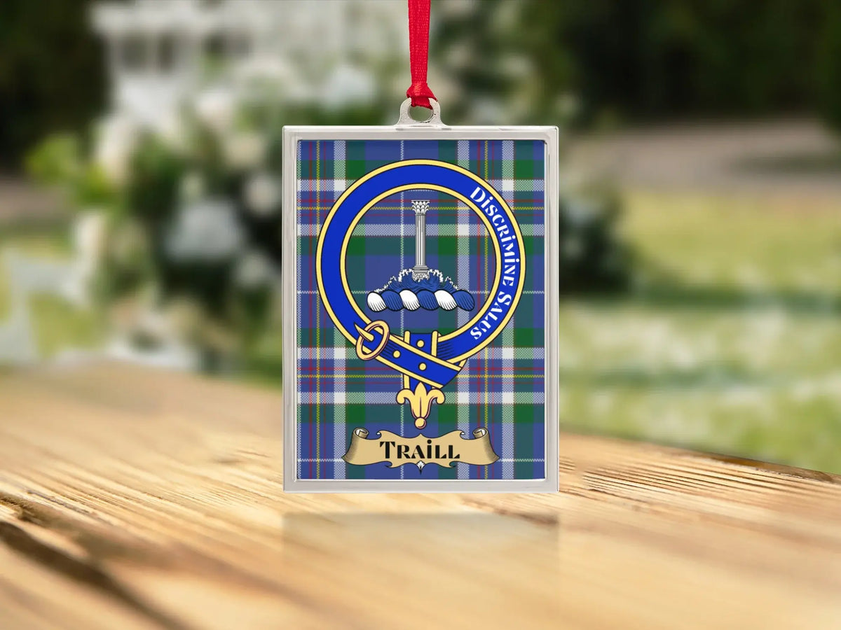 Close-up of the Traill family crest on a polished silver-frame metal ornament