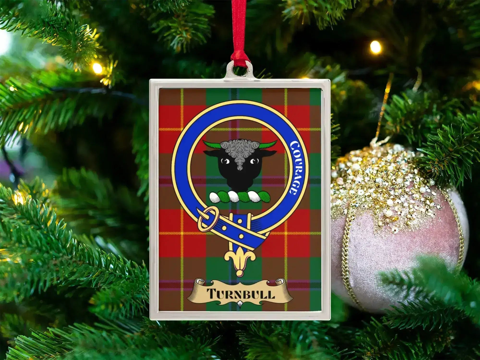 Turnbull clan crest Christmas ornament in a silver frame on a tartan background