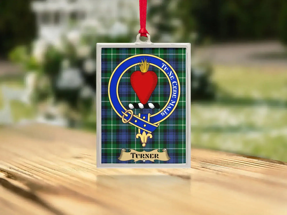 Close-up of the Turner family crest on a polished silver-frame metal ornament