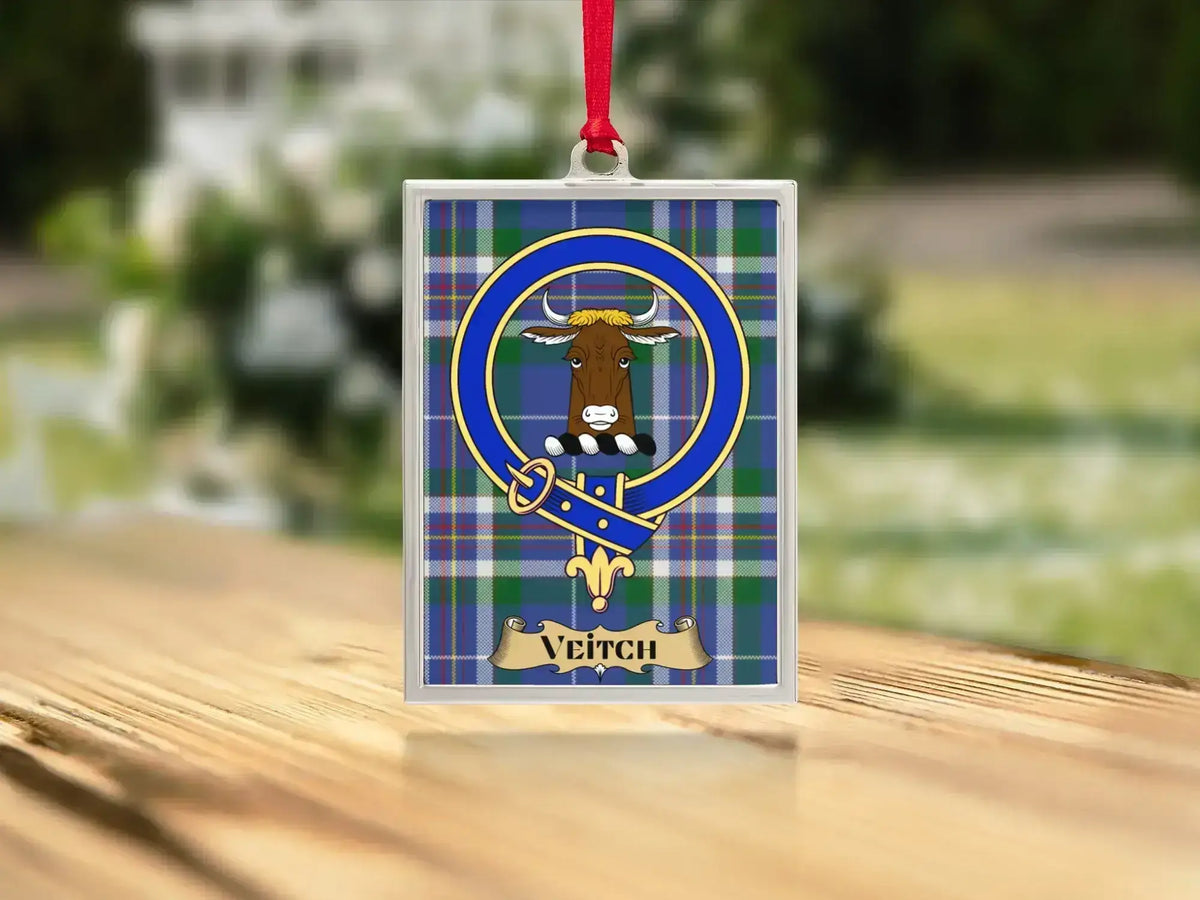 Close-up of the Veitch family crest on a polished silver-frame metal ornament