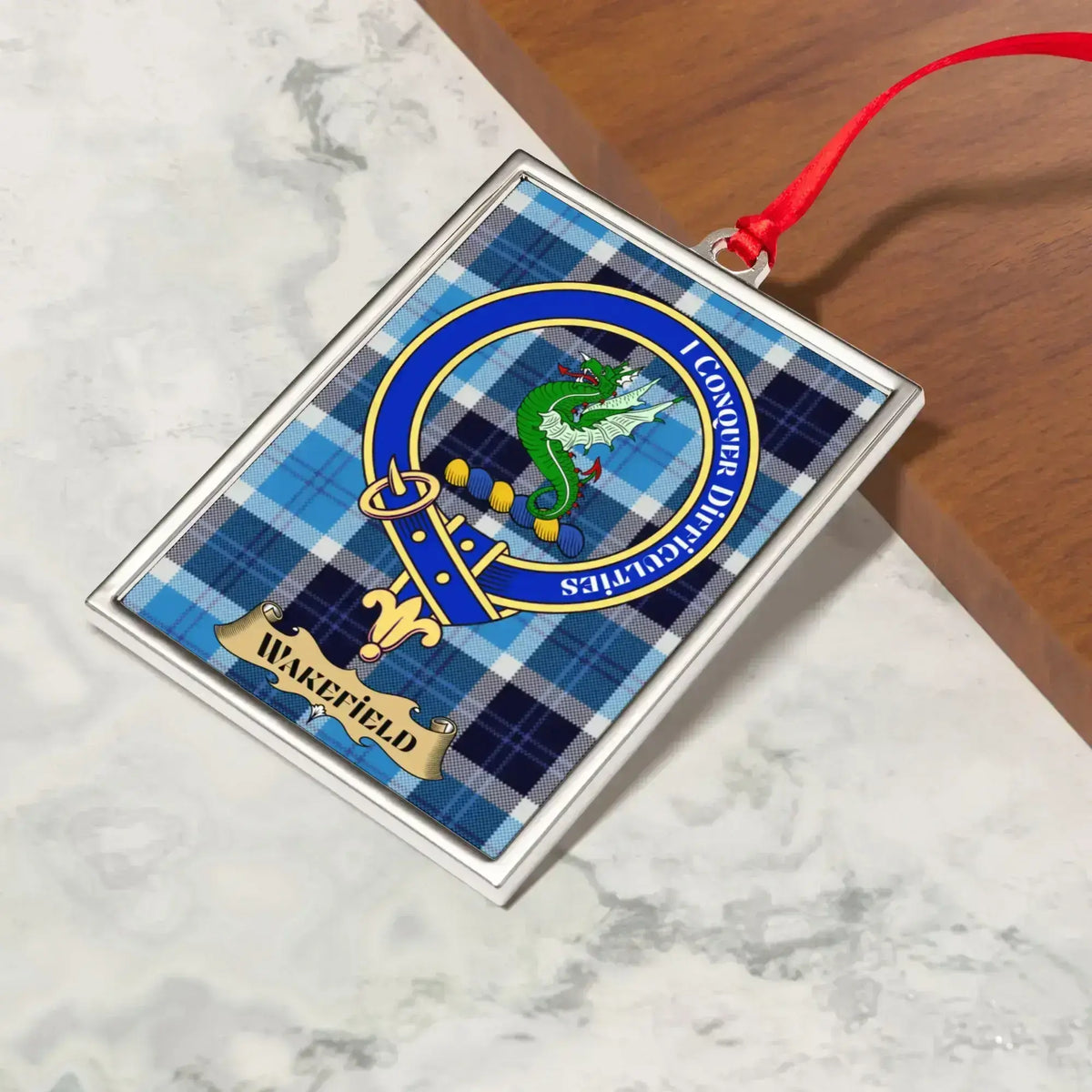 Wakefield ornament hanging from a Christmas tree branch by its satin ribbon