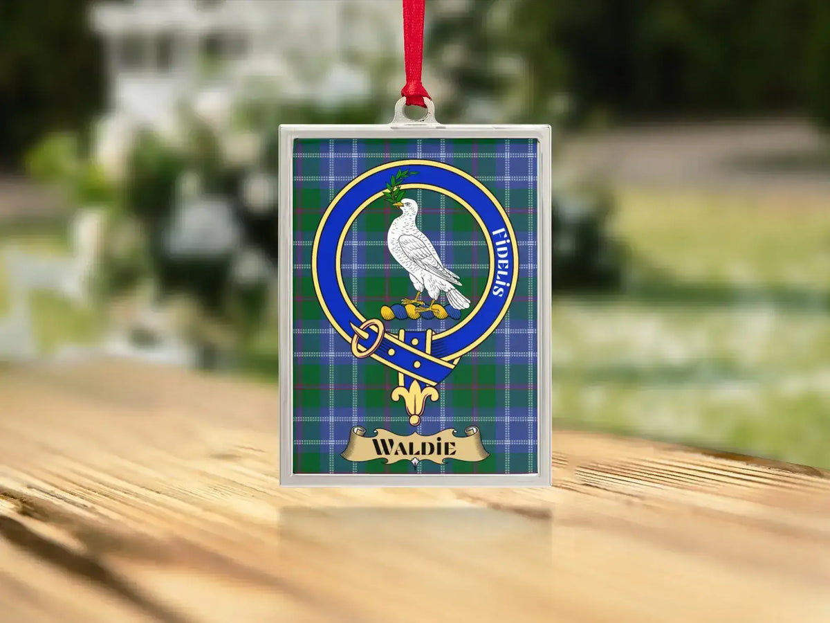 Close-up of the Waldie family crest on a polished silver-frame metal ornament