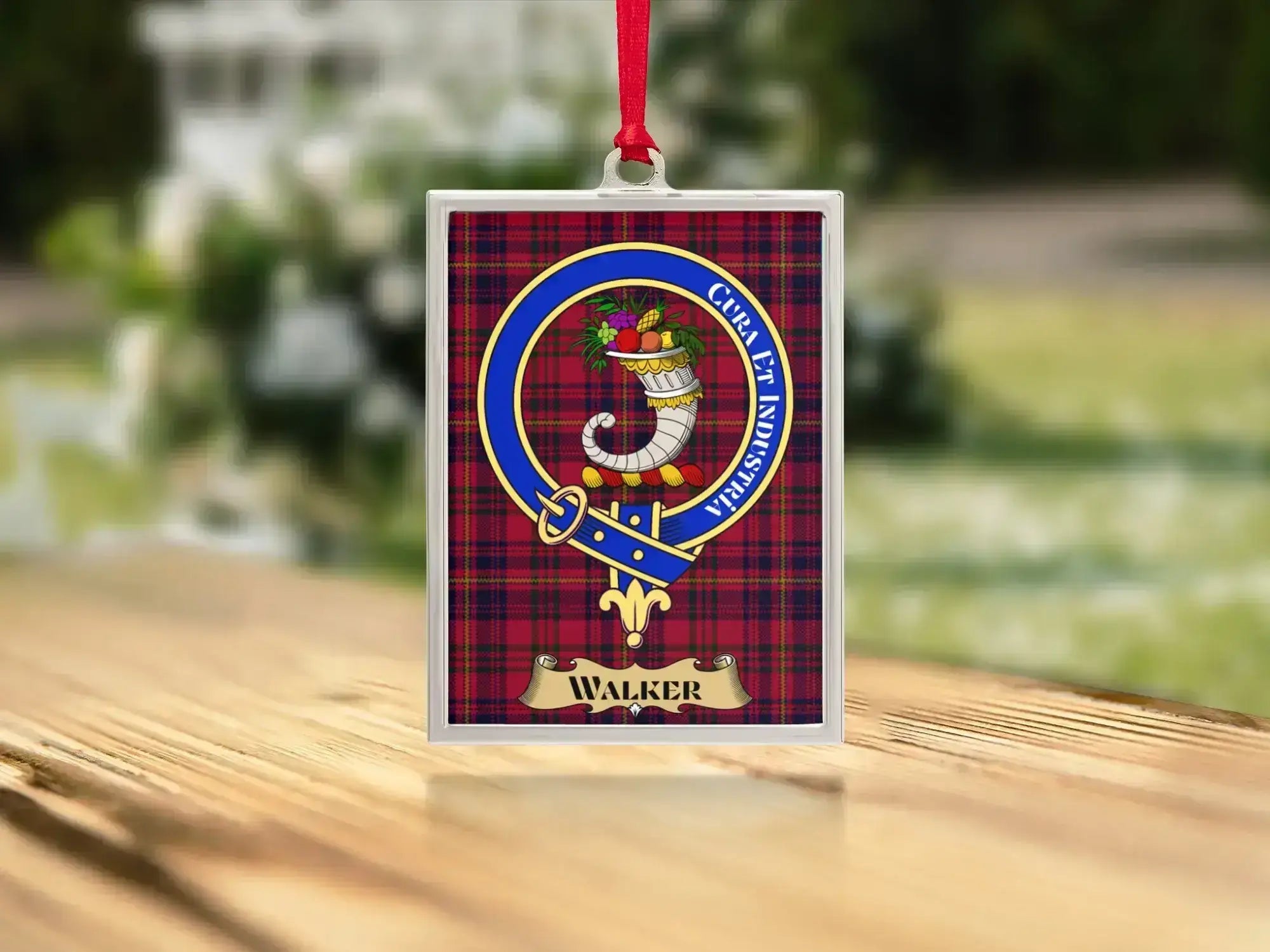 Close-up of the Walker family crest on a polished silver-frame metal ornament