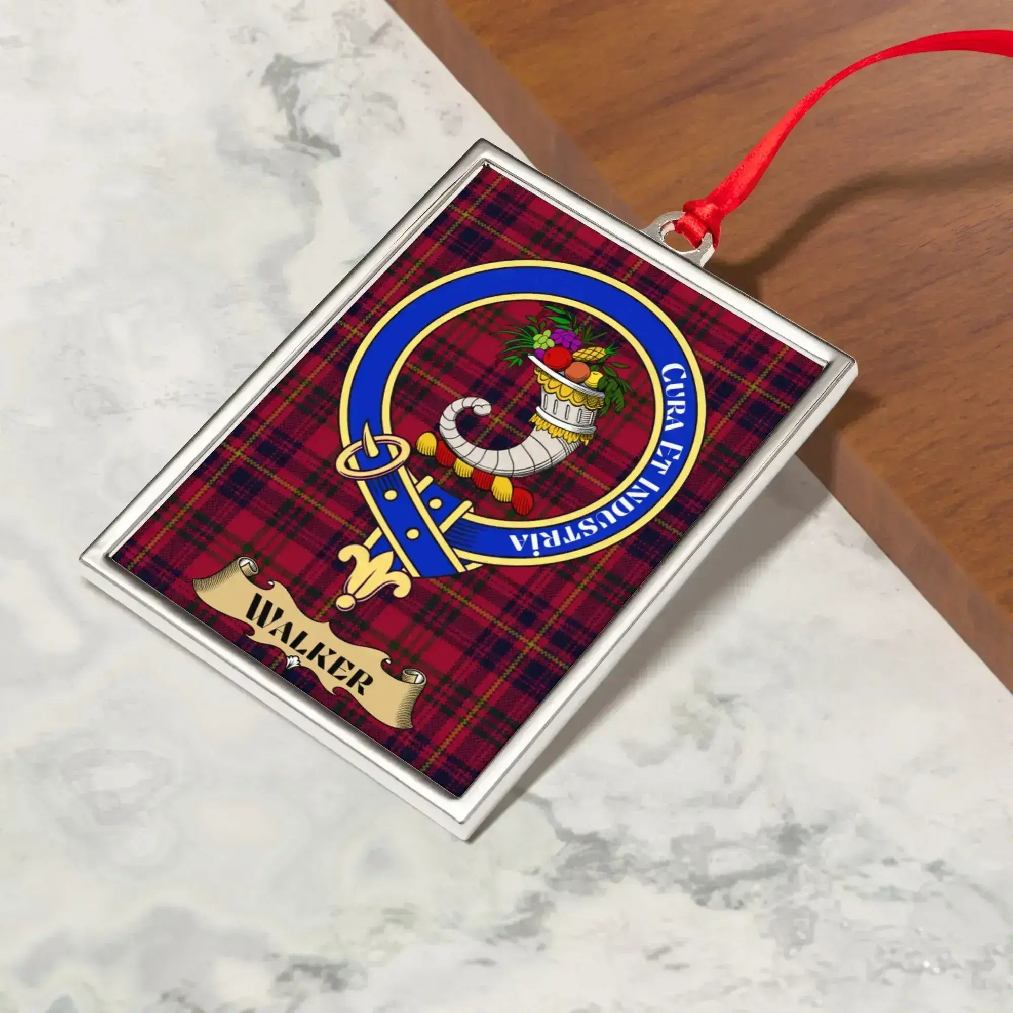 Walker ornament hanging from a Christmas tree branch by its satin ribbon