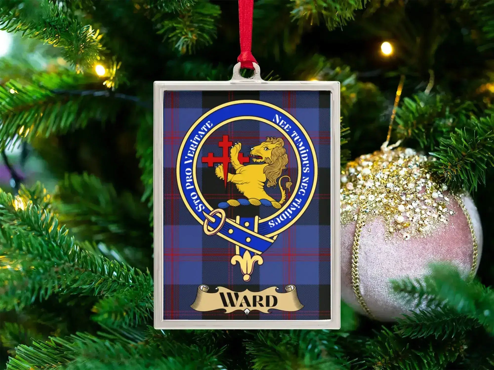 Ward clan crest Christmas ornament in a silver frame on a tartan background
