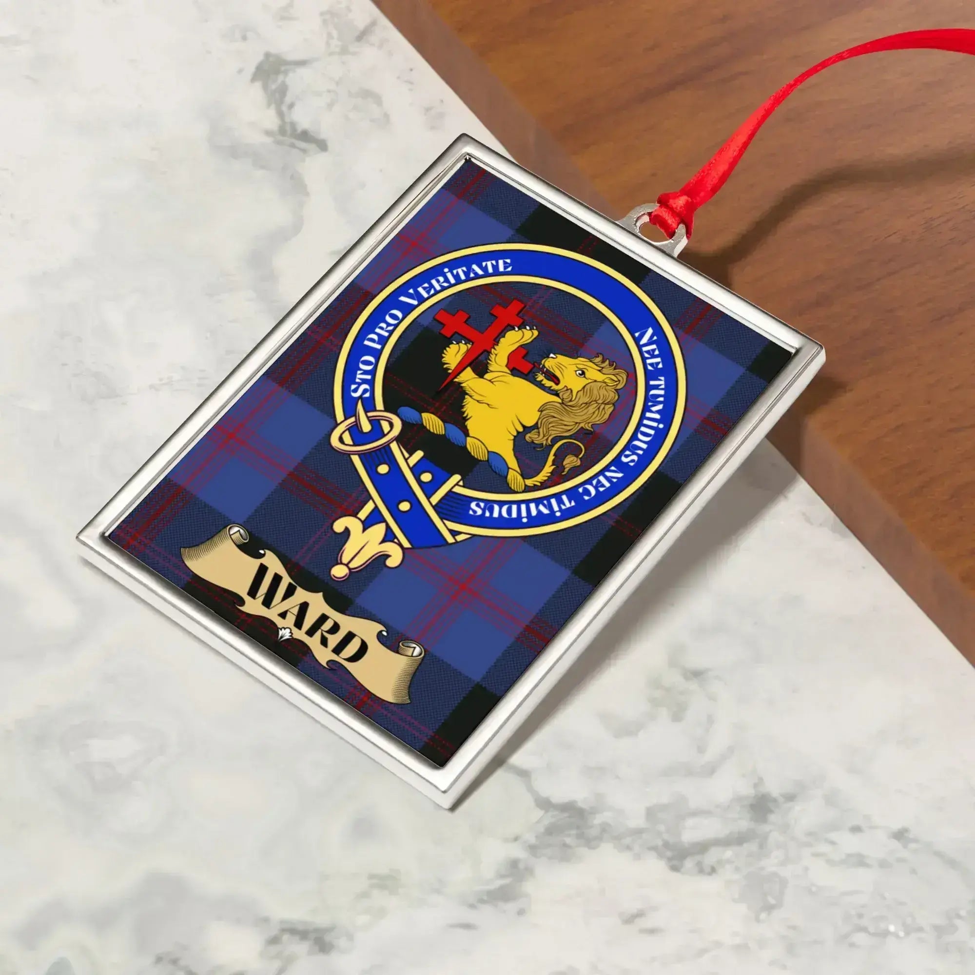 Ward ornament hanging from a Christmas tree branch by its satin ribbon