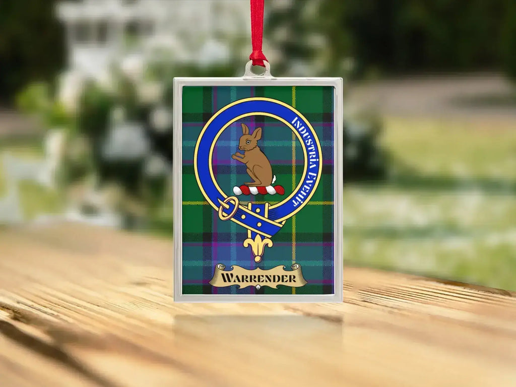 Close-up of the Warrender family crest on a polished silver-frame metal ornament
