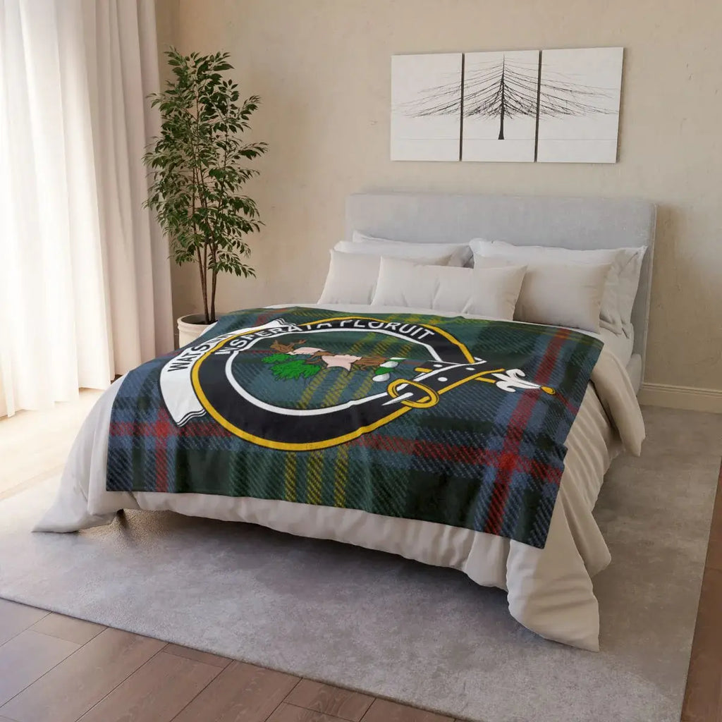 Watson clan tartan throw draped on a sofa — lightweight printed plaid with crest