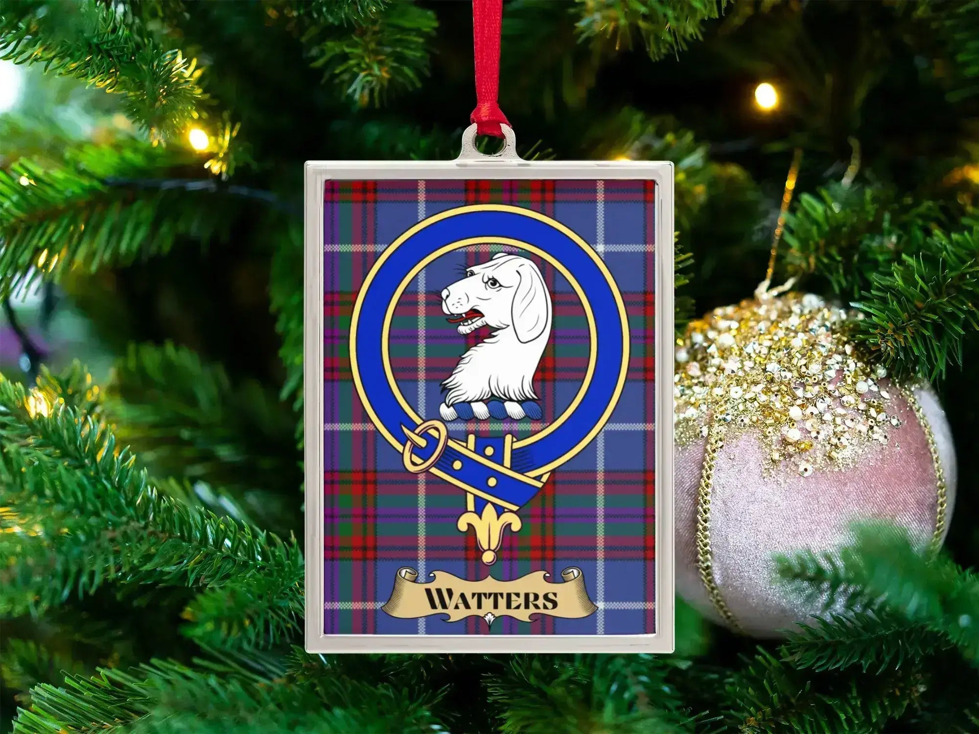 Watters clan crest Christmas ornament in a silver frame on a tartan background