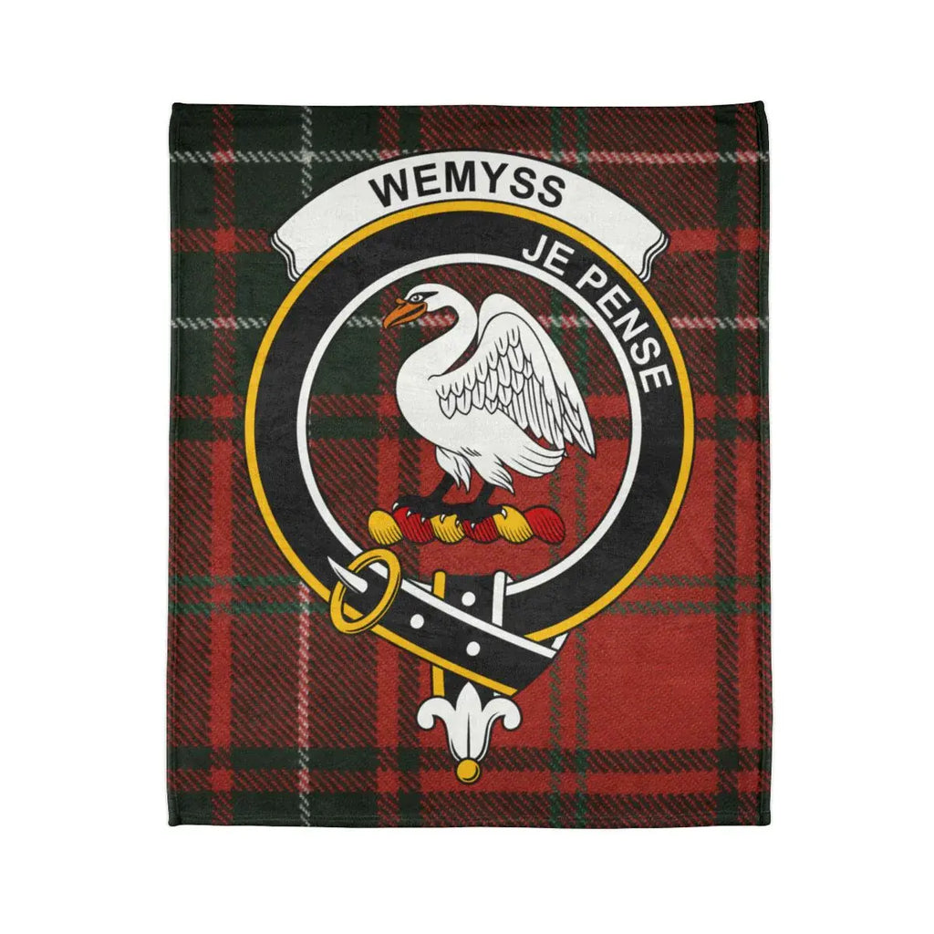 Wemyss family crest emblem on tartan background blanket — swan crest detail