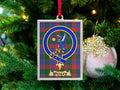 Wenley clan crest Christmas ornament in a silver frame on a tartan background