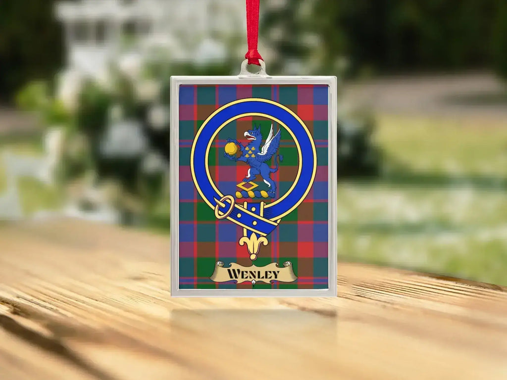Close-up of the Wenley family crest on a polished silver-frame metal ornament