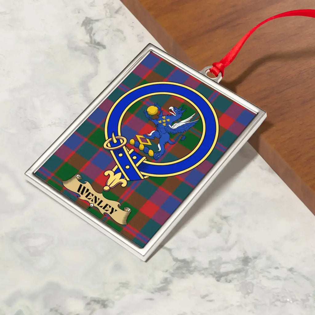 Wenley ornament hanging from a Christmas tree branch by its satin ribbon