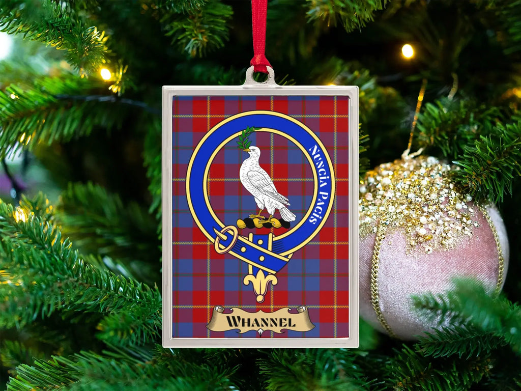 Whannel clan crest Christmas ornament in a silver frame on a tartan background