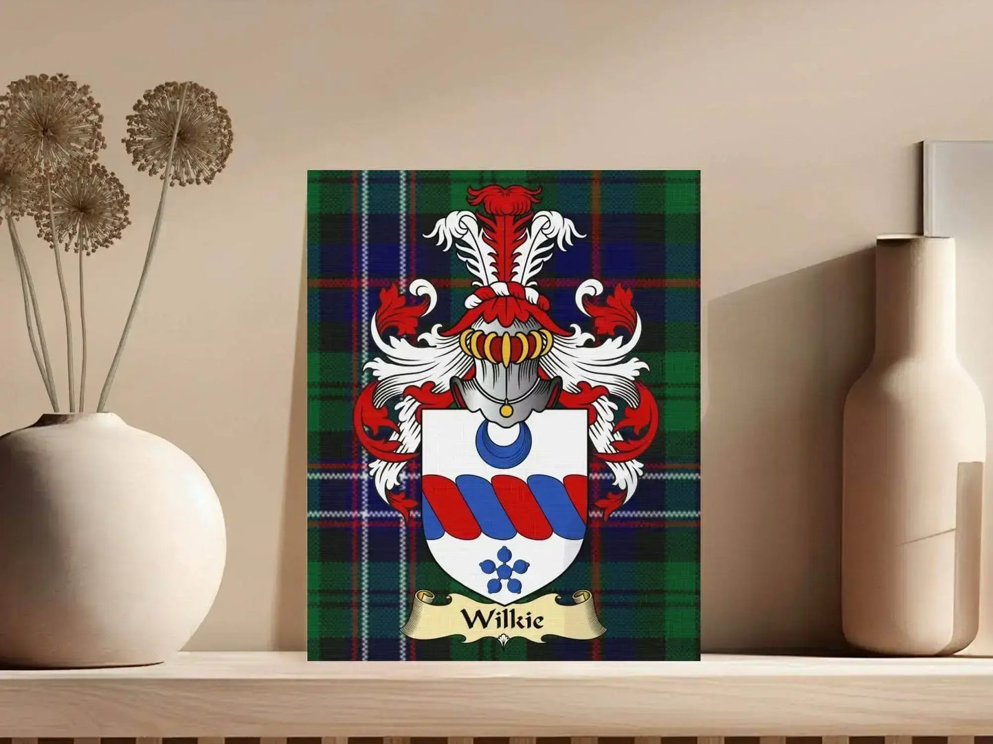Wilkie clan coat of arms featuring red and blue shield on green tartan canvas wrap displayed on shelf