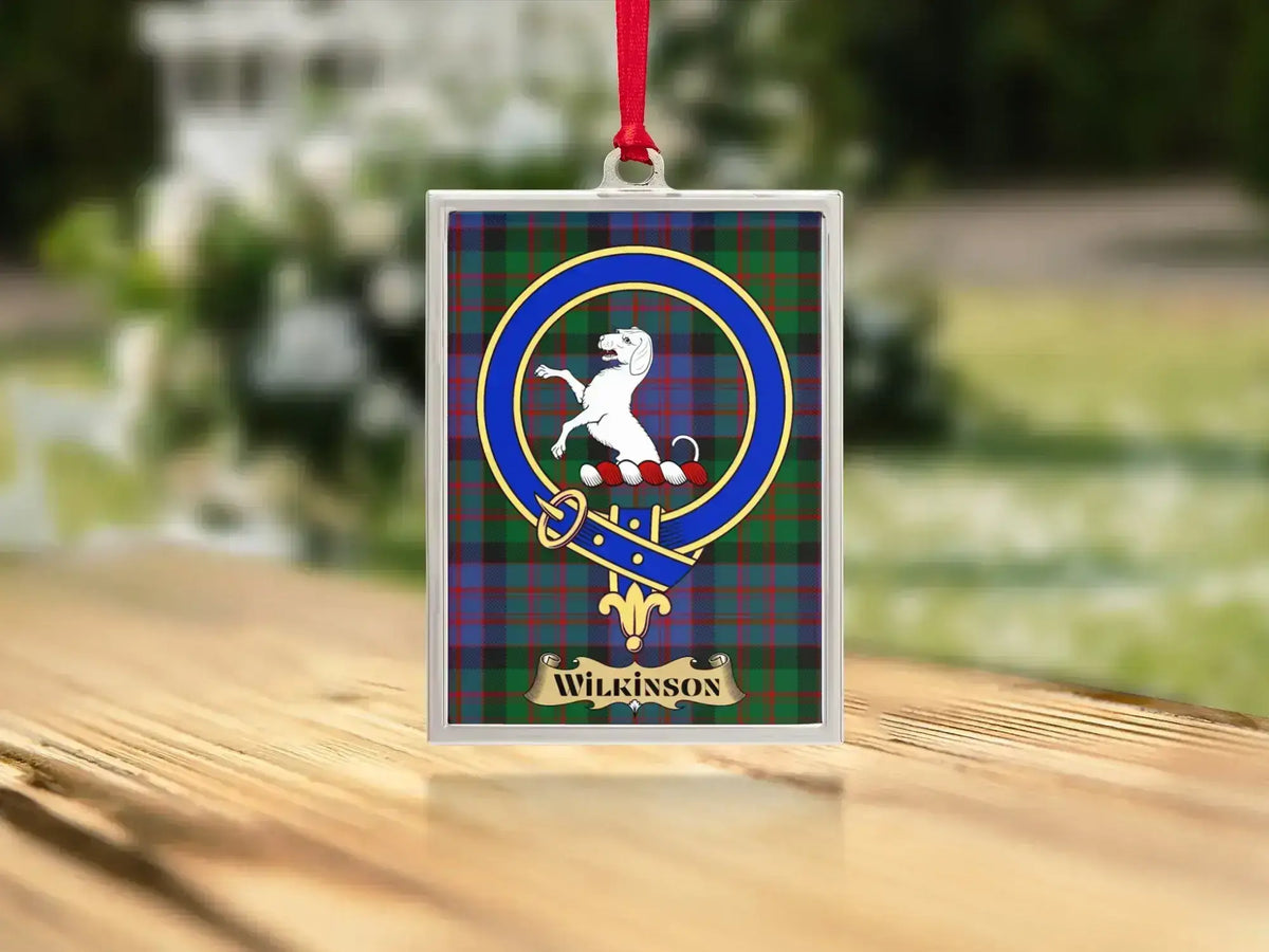 Close-up of the Wilkinson family crest on a polished silver-frame metal ornament