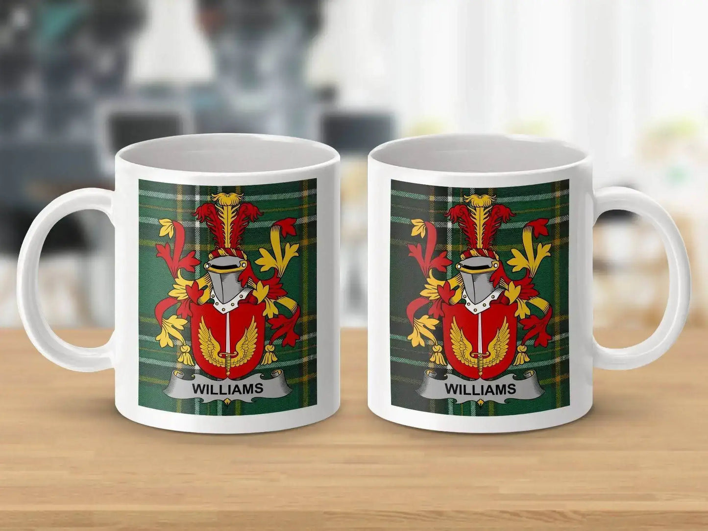 Two white mugs on wooden table with Williams family crest on green tartan background