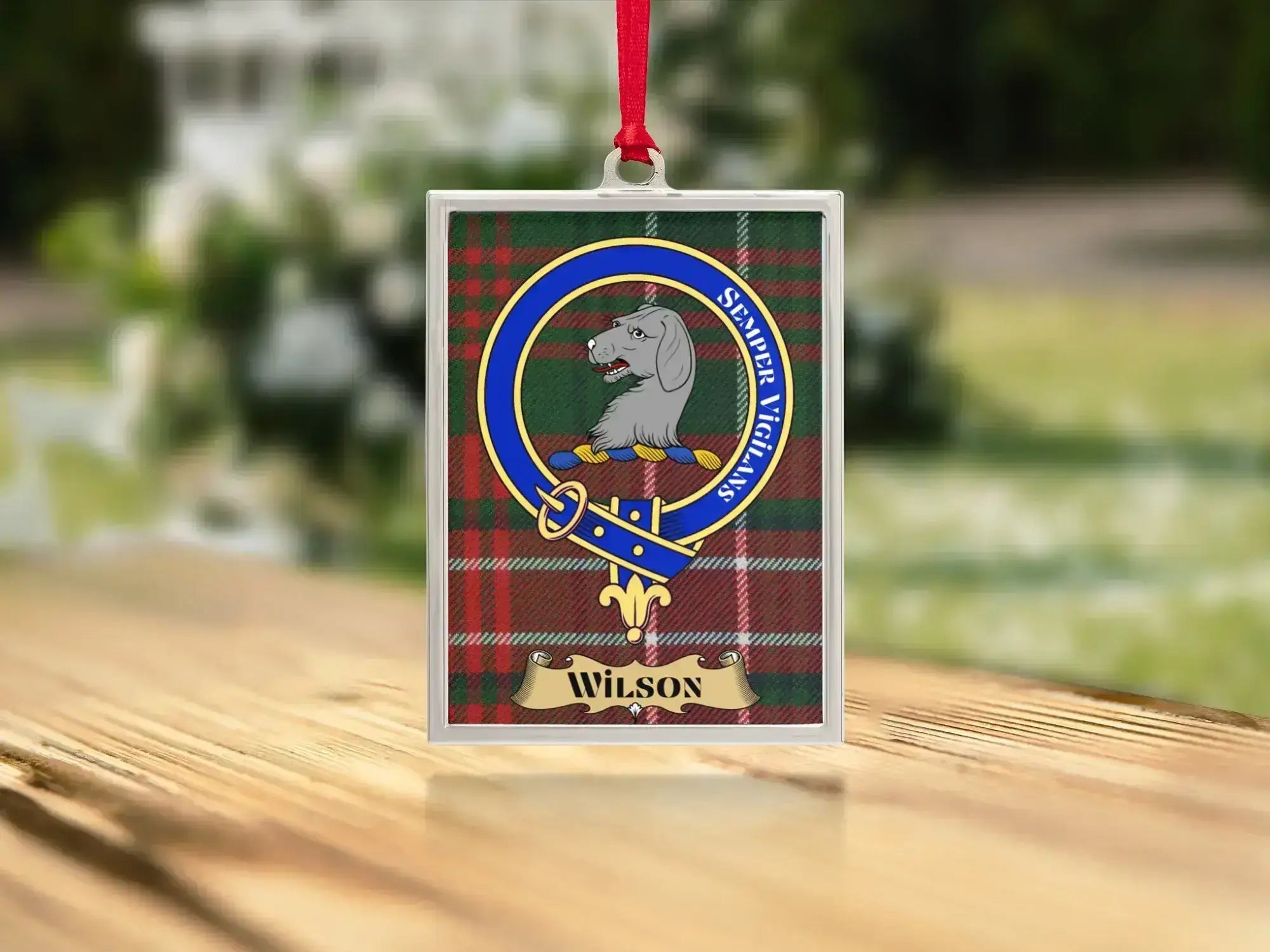 Close-up of the Wilson family crest on a polished silver-frame metal ornament