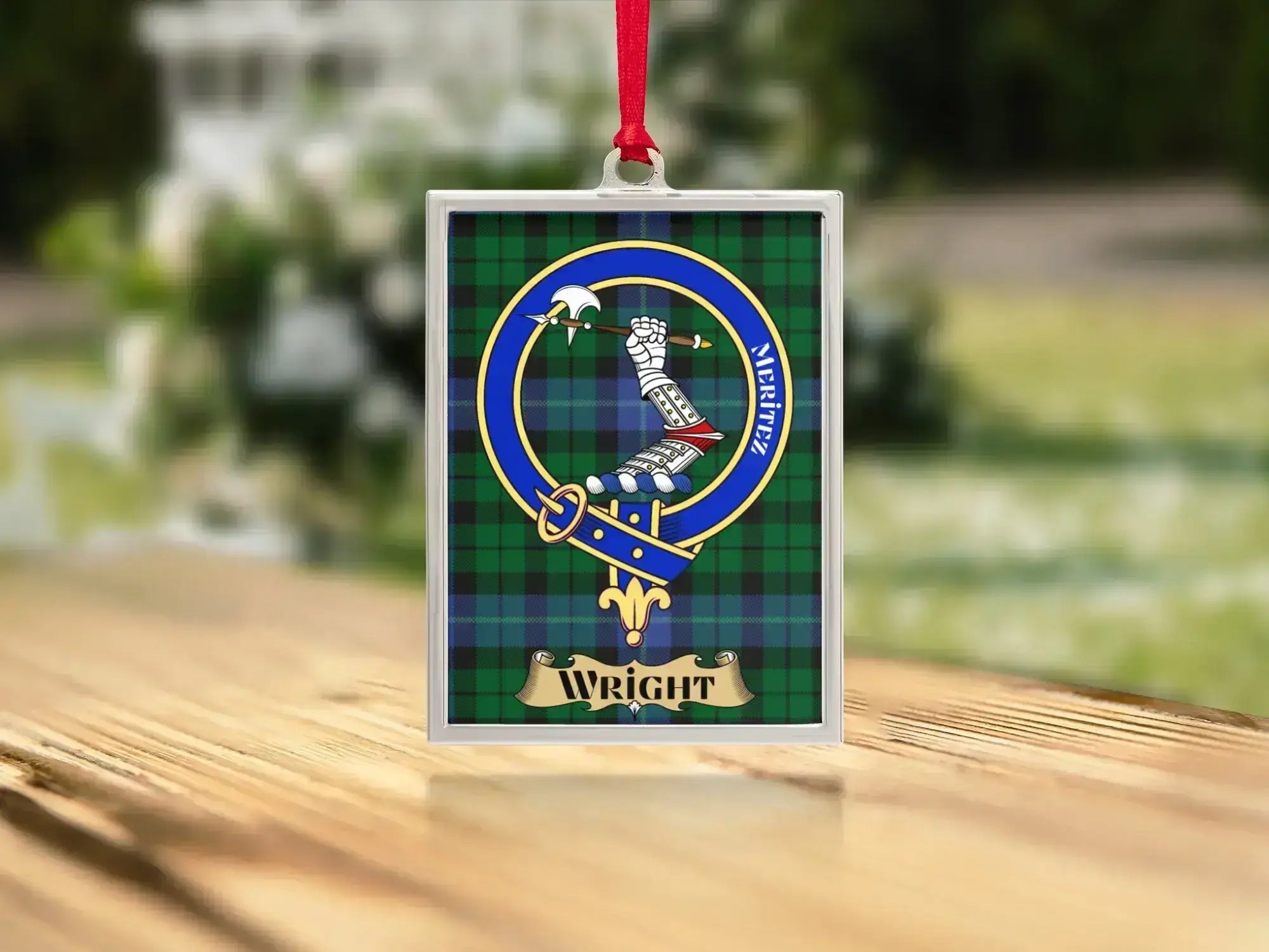 Close-up of the Wright family crest on a polished silver-frame metal ornament