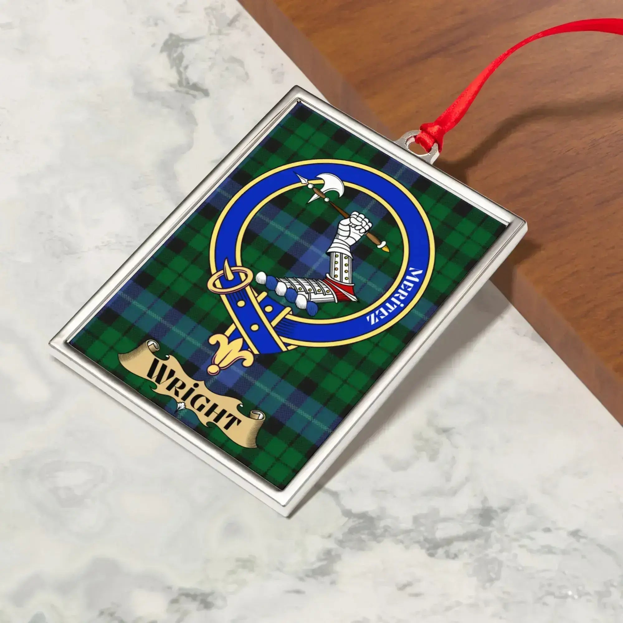 Wright ornament hanging from a Christmas tree branch by its satin ribbon