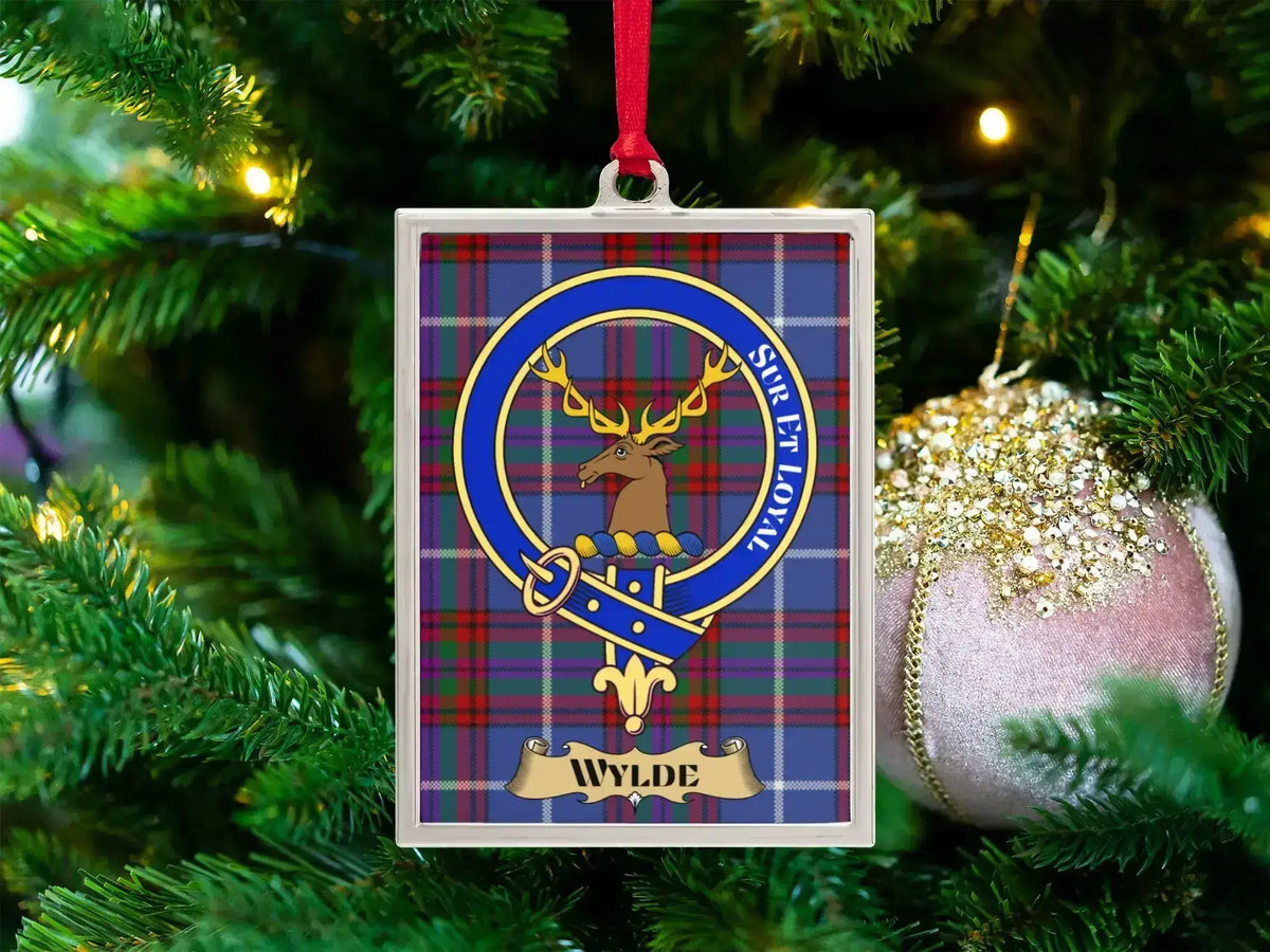 Wylde clan crest Christmas ornament in a silver frame on a tartan background