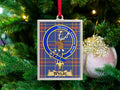 Wylie clan crest Christmas ornament in a silver frame on a tartan background