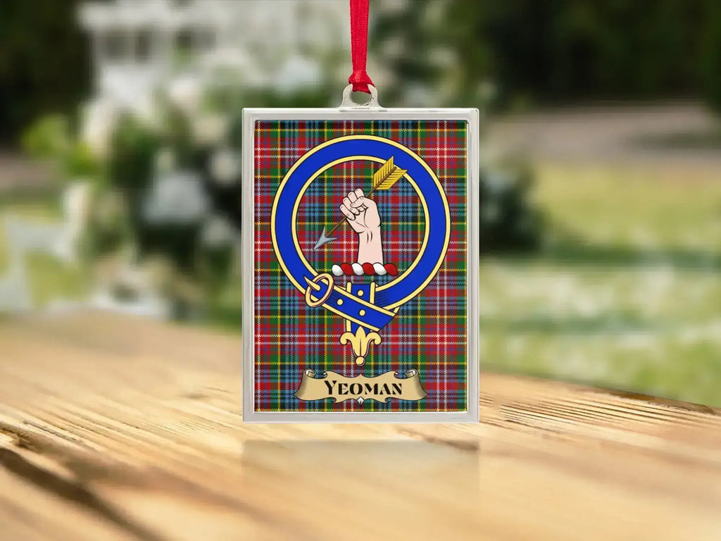 Close-up of the Yeoman family crest on a polished silver-frame metal ornament