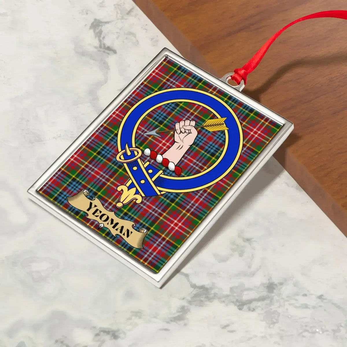 Yeoman ornament hanging from a Christmas tree branch by its satin ribbon