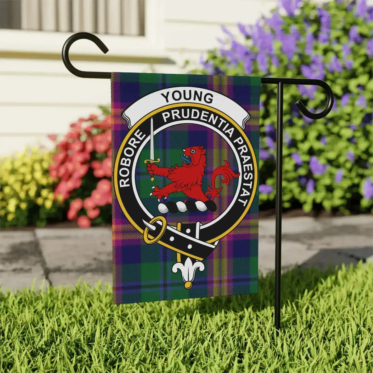 Young Scottish tartan garden flag displayed outdoors on a stand
