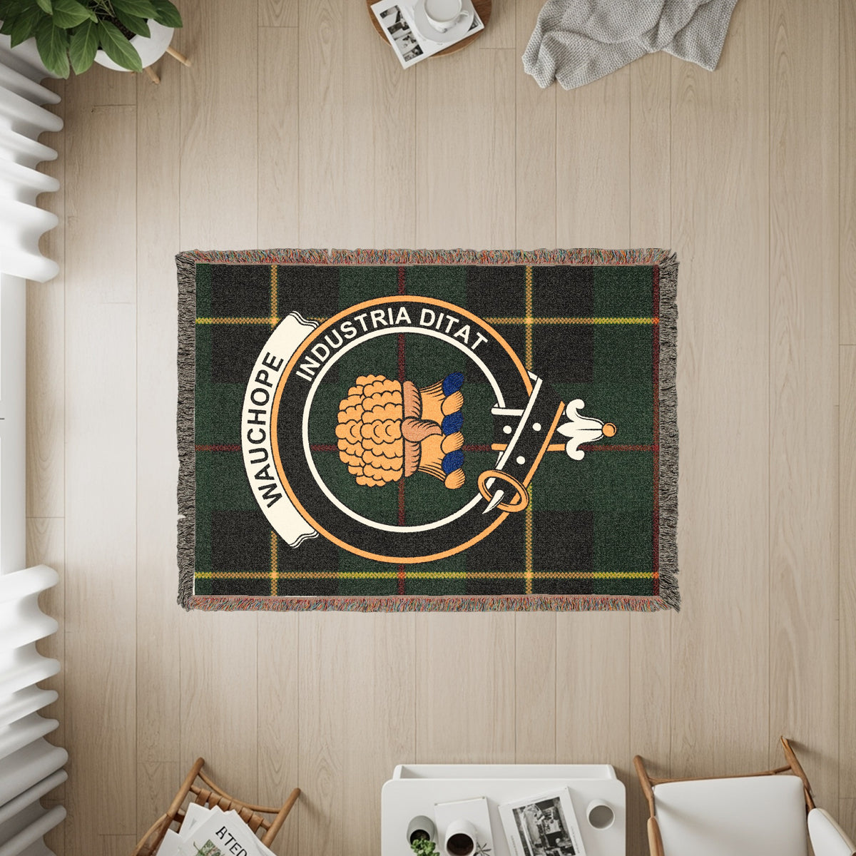 Wauchope woven blanket displayed on a wall, featuring the crest badge and tartan background