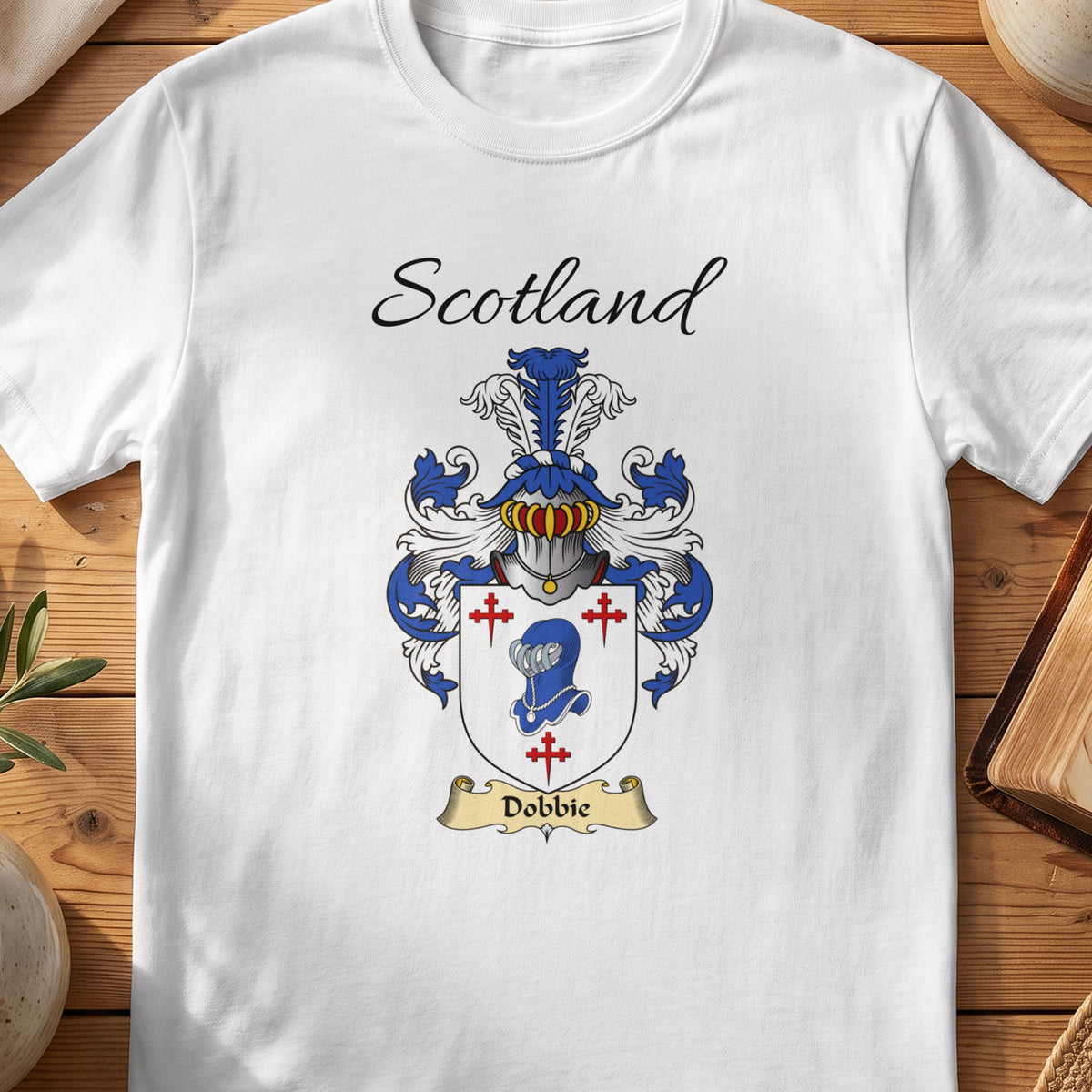 White Dobbie Scottish family shield T-shirt featuring a blue animal head surrounded by red crosses