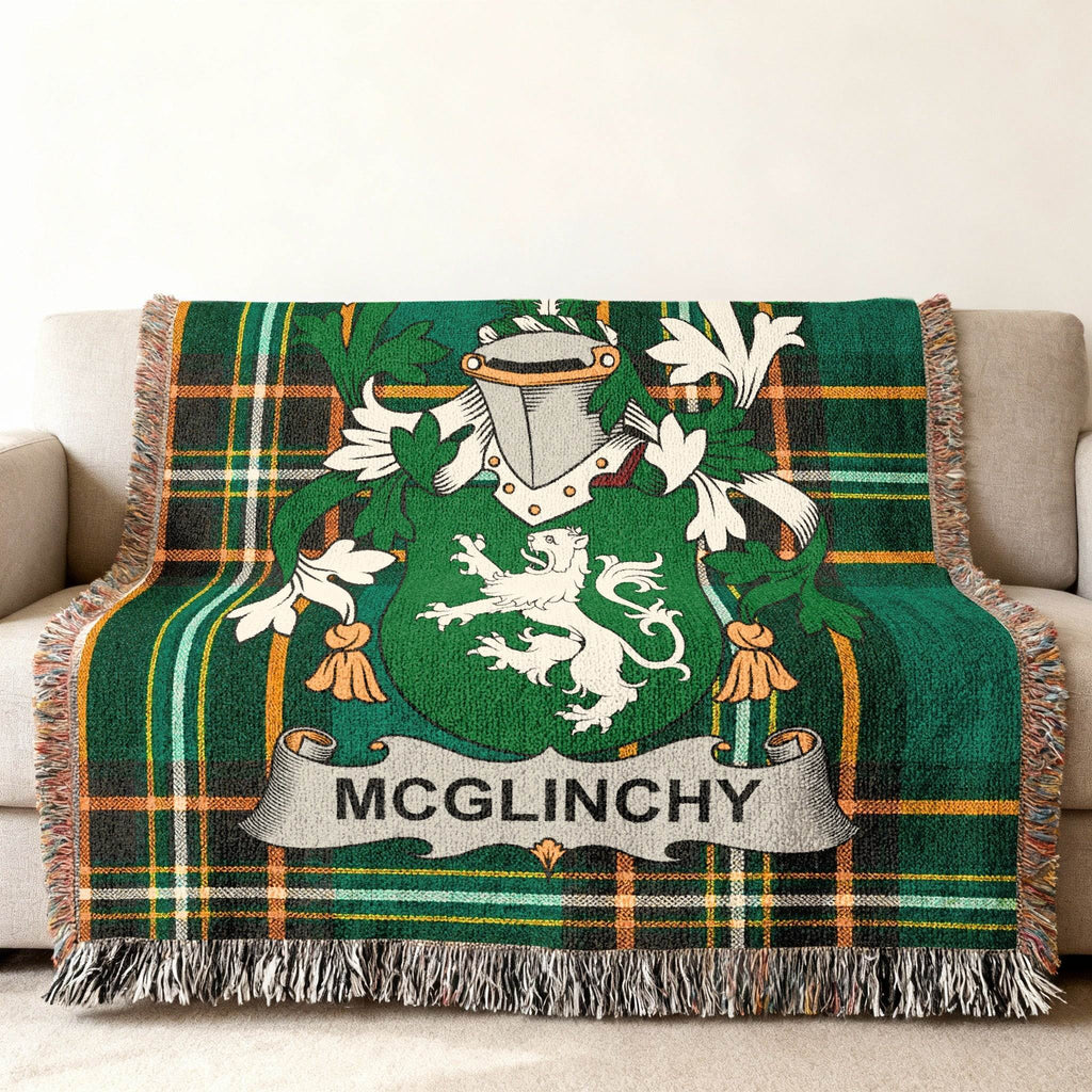 Green tartan throw blanket with McGlinchy family crest displayed.