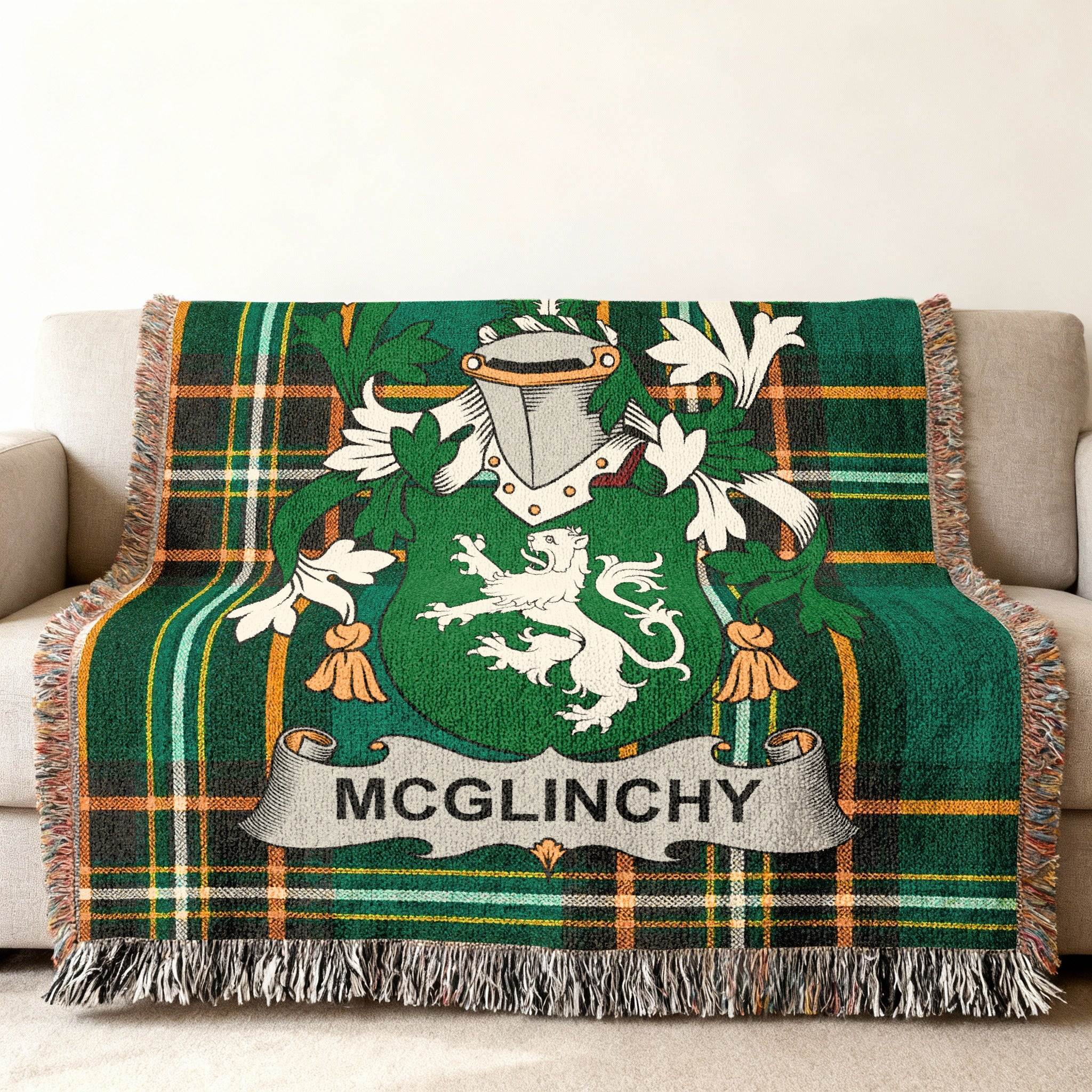 Green tartan throw blanket with McGlinchy family crest displayed.