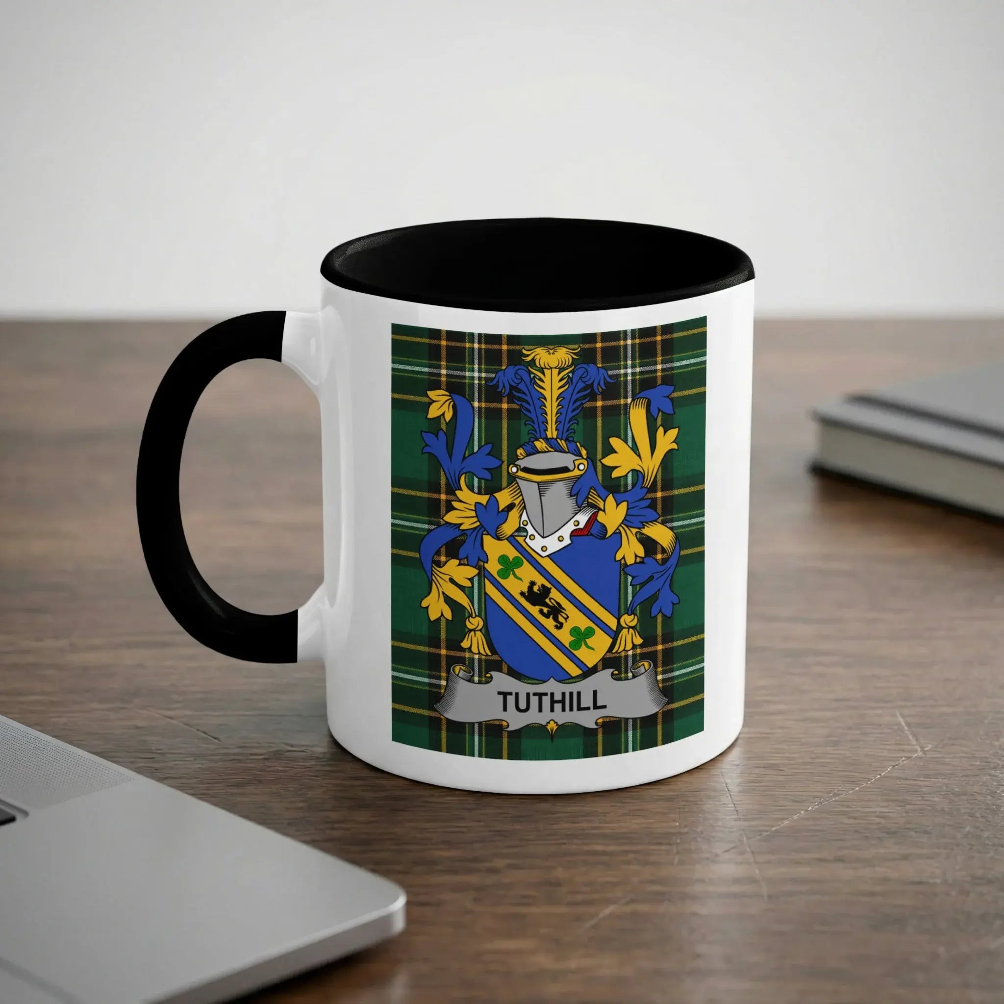 White mug with black handle featuring the TUTHILL family crest on a plaid background.