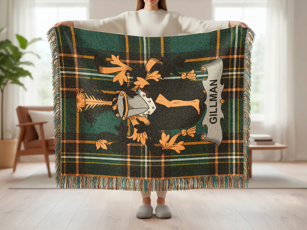 Green tartan blanket with a shield and crest design, featuring the name "GILLMAN".