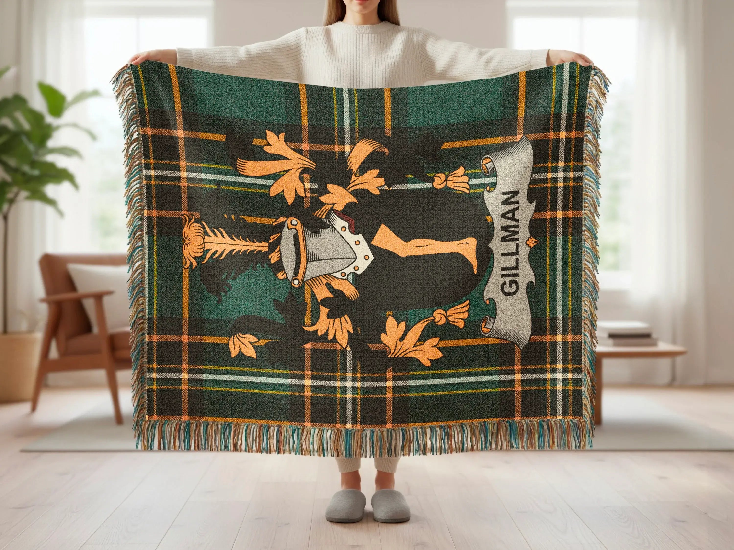 Green tartan blanket with a shield and crest design, featuring the name "GILLMAN".