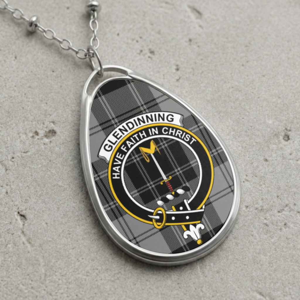 Glendinning clan Scottish tartan necklace with clan crest and Have Faith in Christ motto on tartan background
