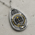 Glendinning clan Scottish tartan necklace with clan crest and Have Faith in Christ motto on tartan background
