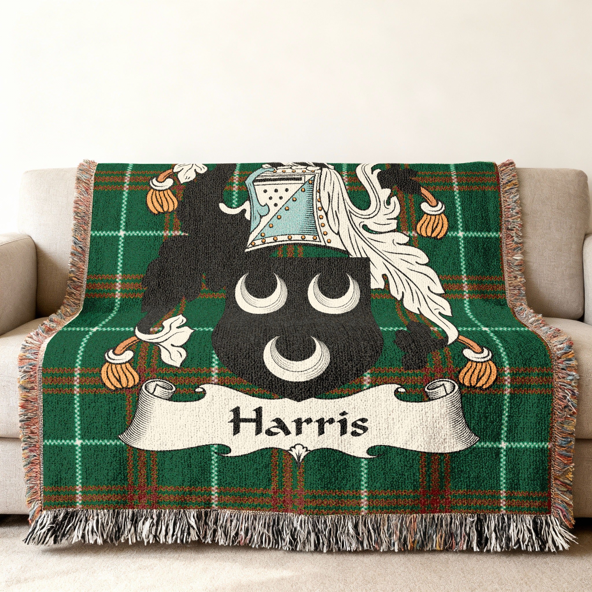 Woven throw blanket with green tartan and the Harris family crest.